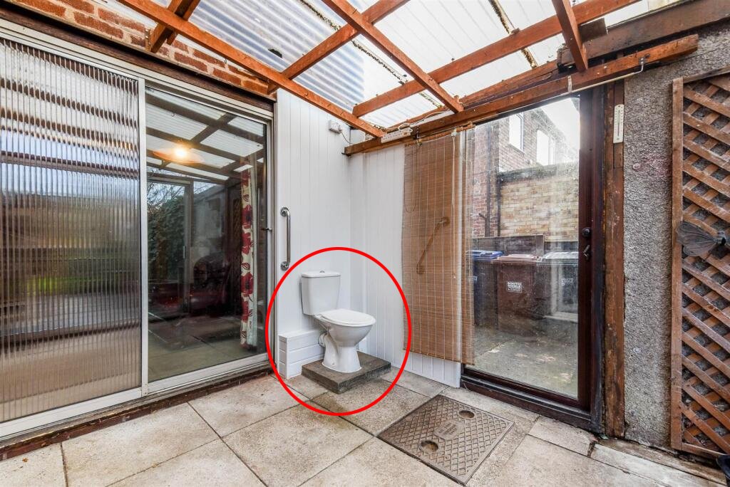 A three bedroom home priced at £130,000 has caught attention for its unusual layout, featuring a fully plumbed toilet sitting openly inside a glass conservatory